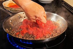 Add The Tomatoes To The Pan