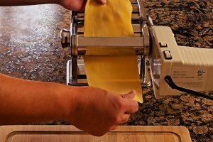 Dough Passing Through The Pasta Machine Roller